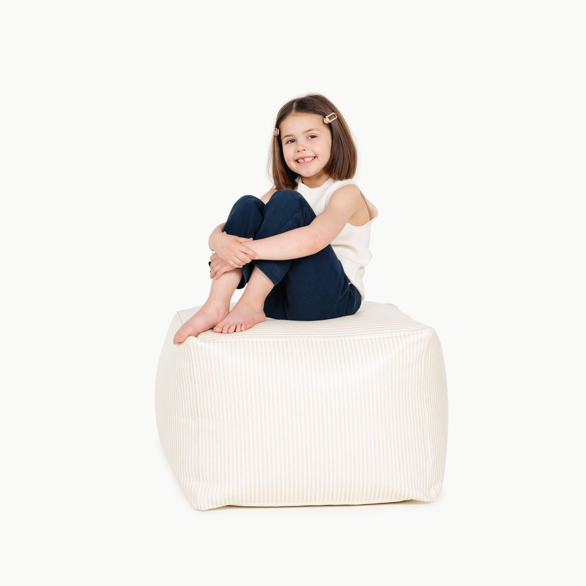 Pinstripe (on sale)@little girl sitting on a square pouf