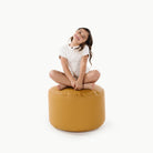 Saffron (on sale)@little girl sitting on a circle pouf