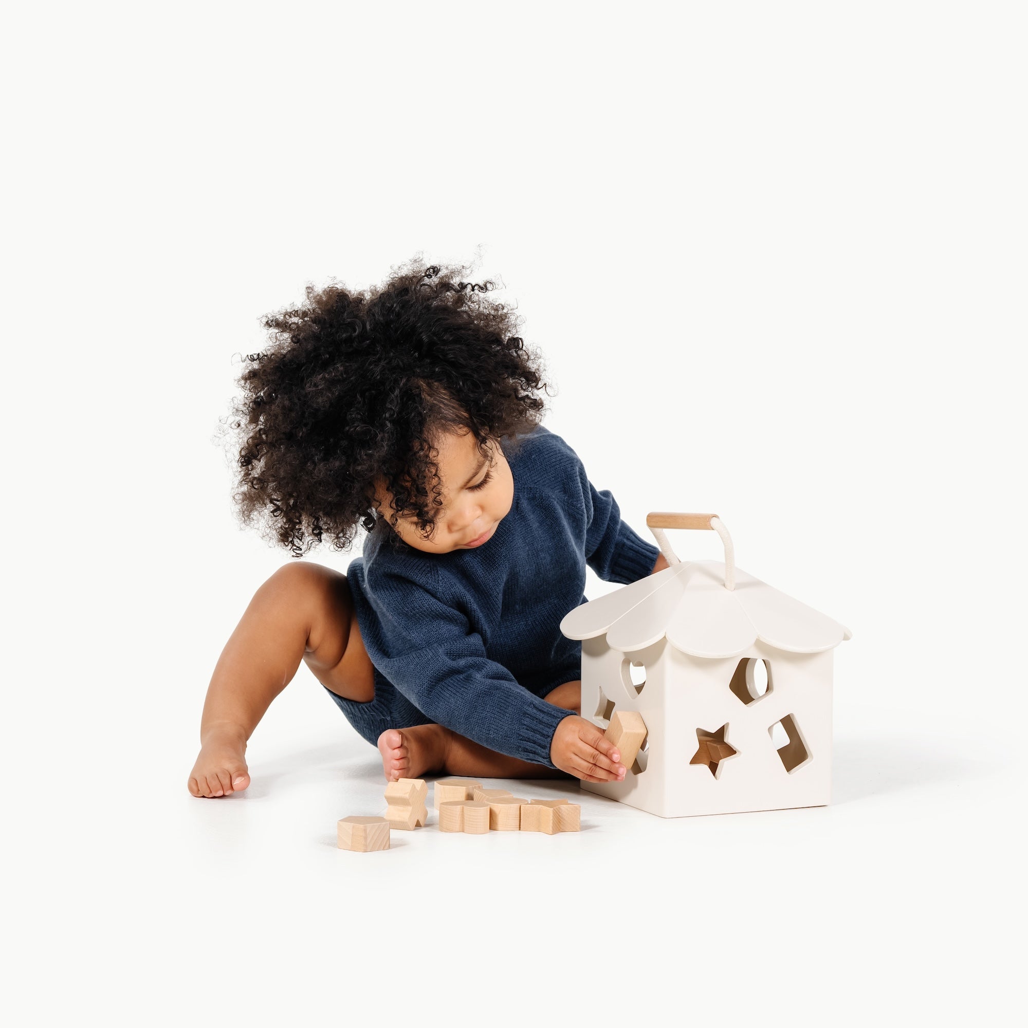 Ivory (on sale)@Baby using a shape sorter to practice fine motor skills