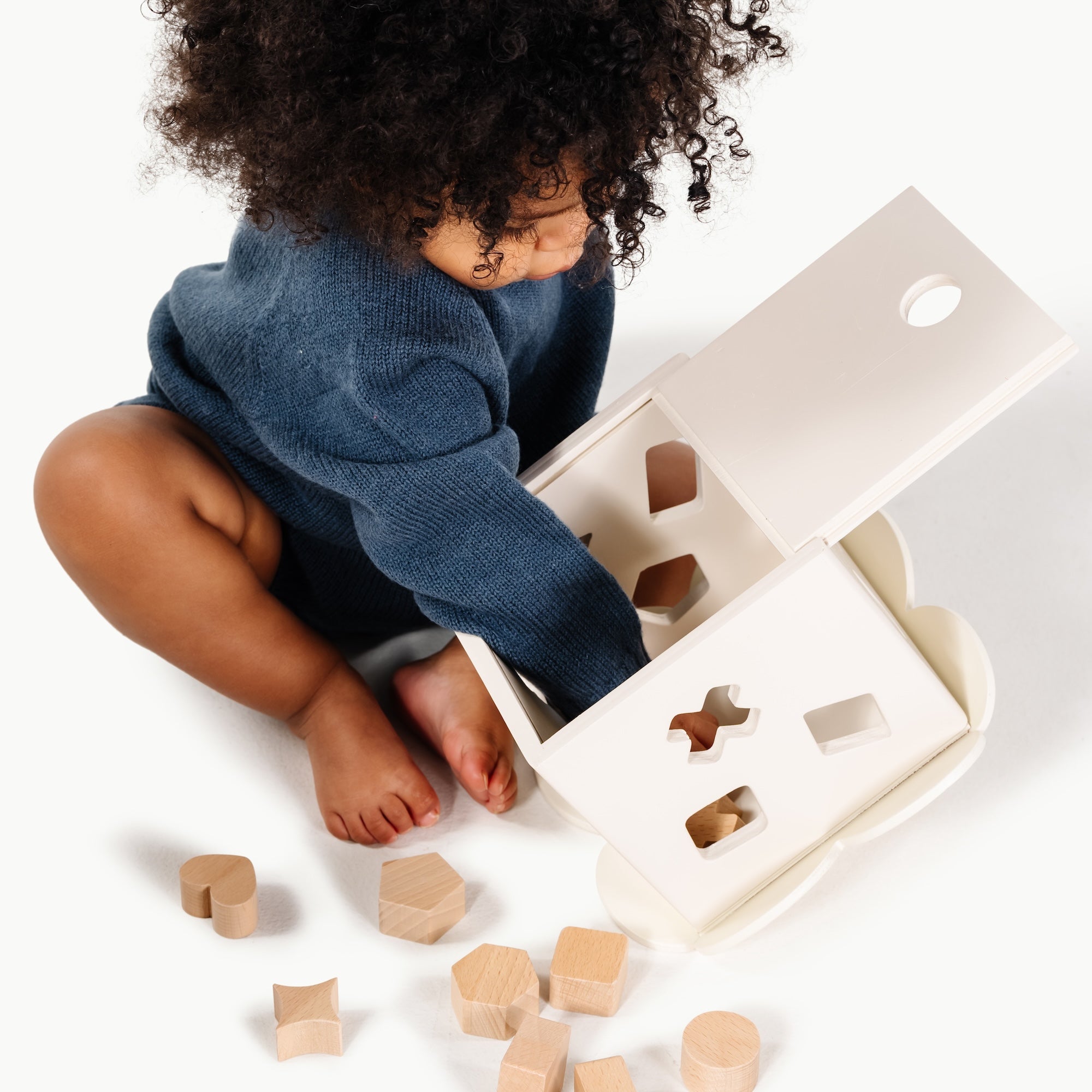 Ivory (on sale)@Baby using a shape sorter to practice fine motor skills