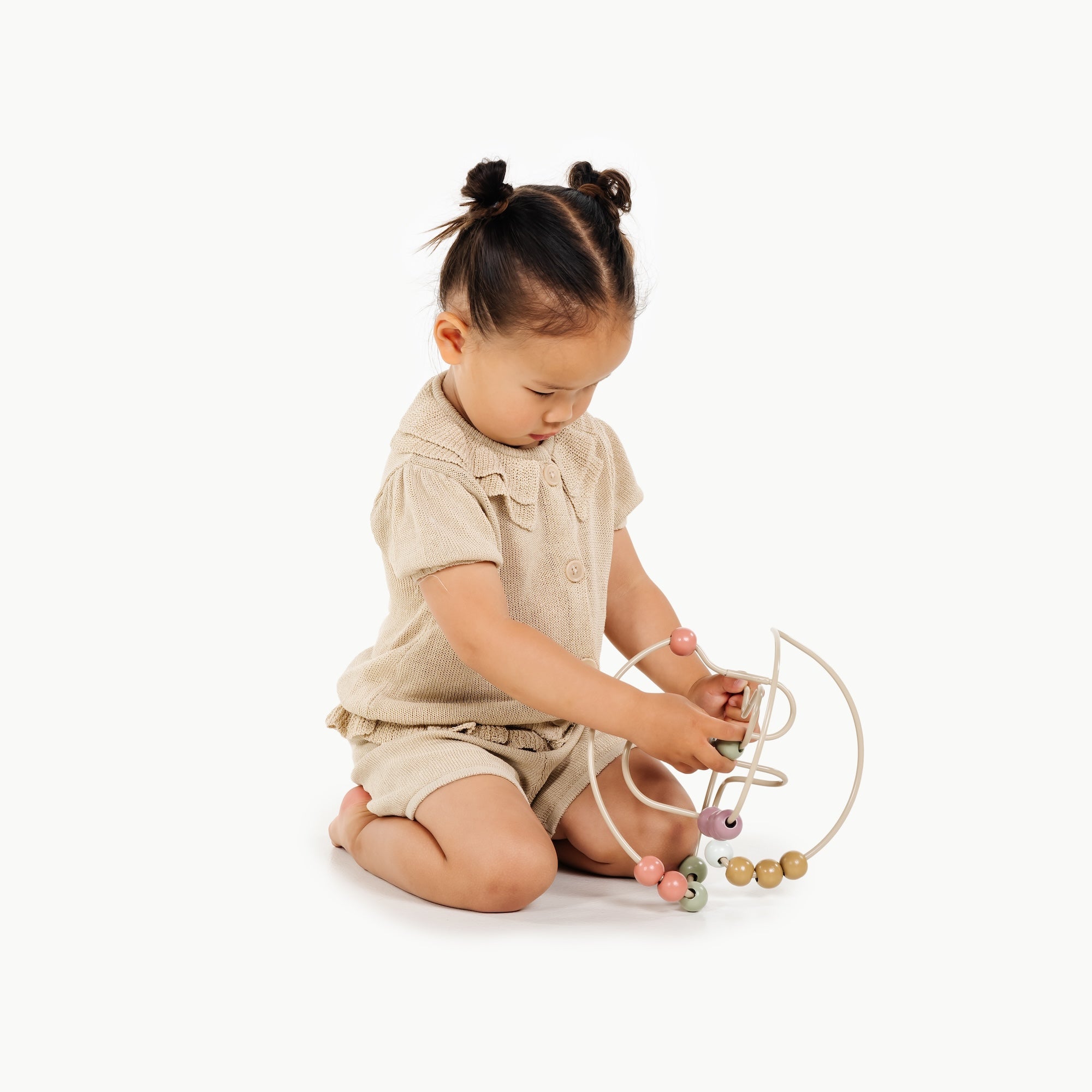 Biscotti / Circle@Baby engaging with bead maze to build hand-eye coordination