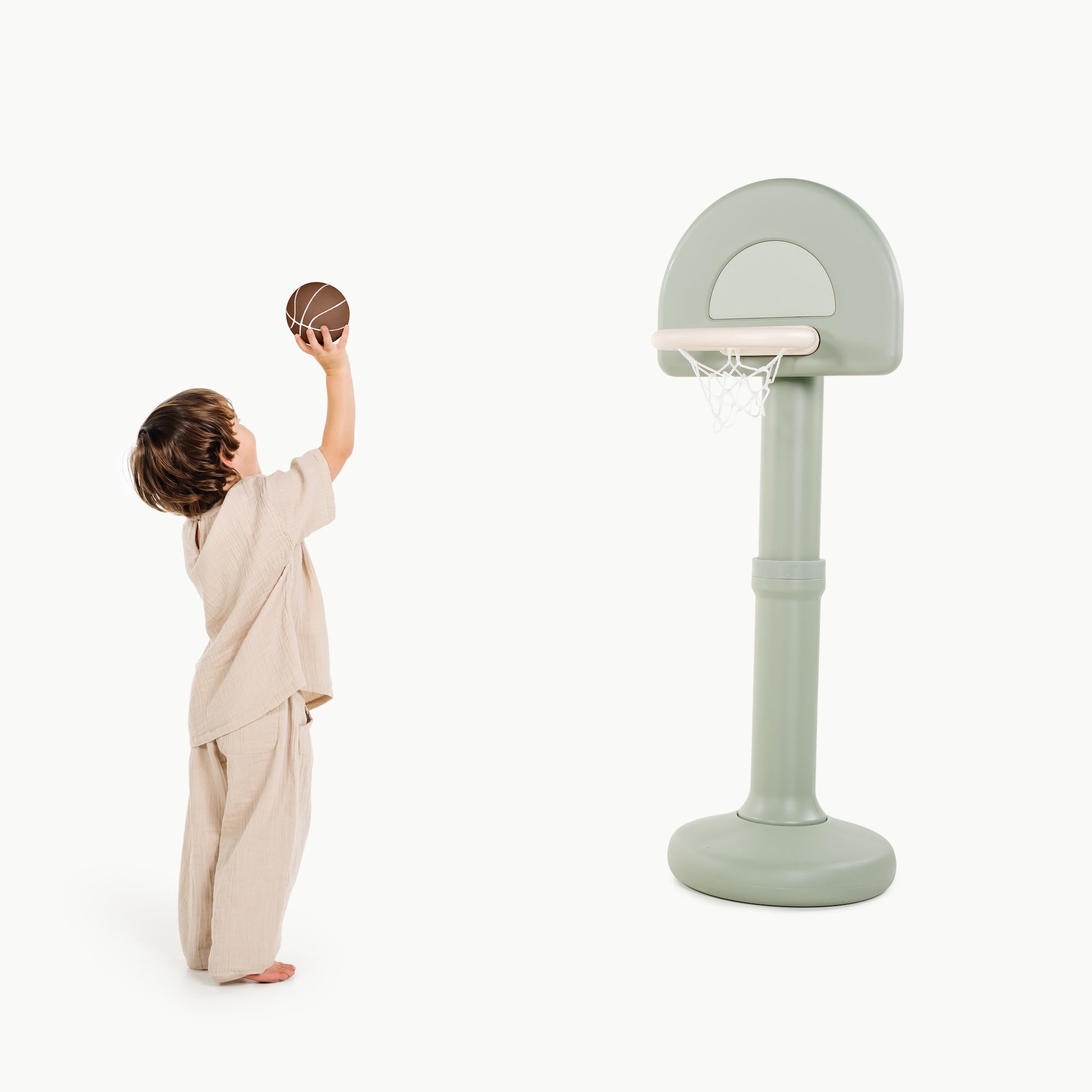 Palm@Toddler using a basketball hoop to practice coordination and movement