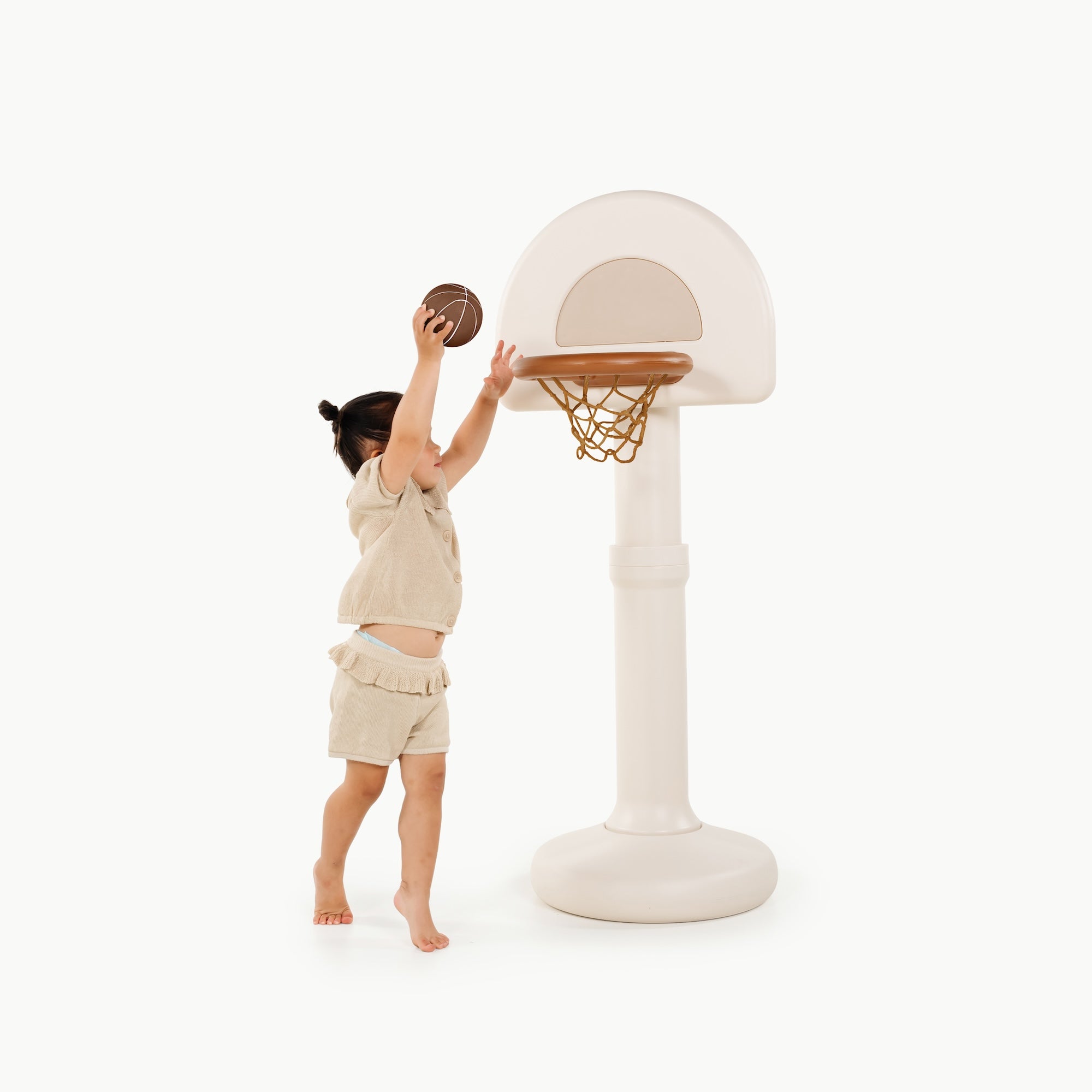 Ivory@Toddler using a basketball hoop to practice coordination and movement