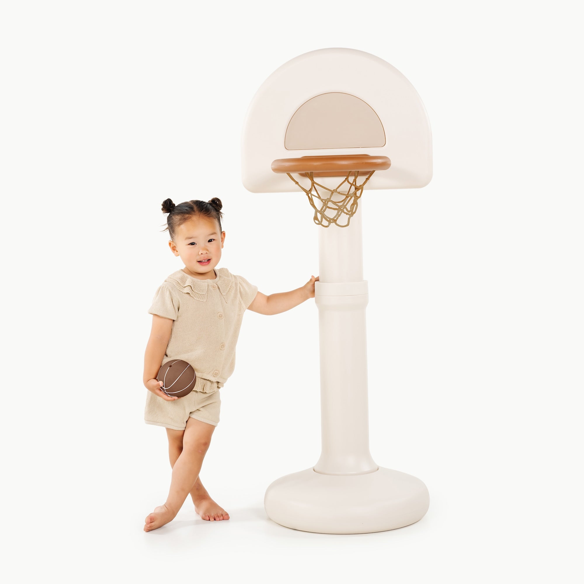 Ivory@Toddler using a basketball hoop to practice coordination and movement