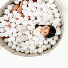 Stone Stripe@Child playing in a soft ball pit designed for babies and toddlers