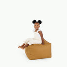 Tassel (on sale)@little girl sitting on pouf
