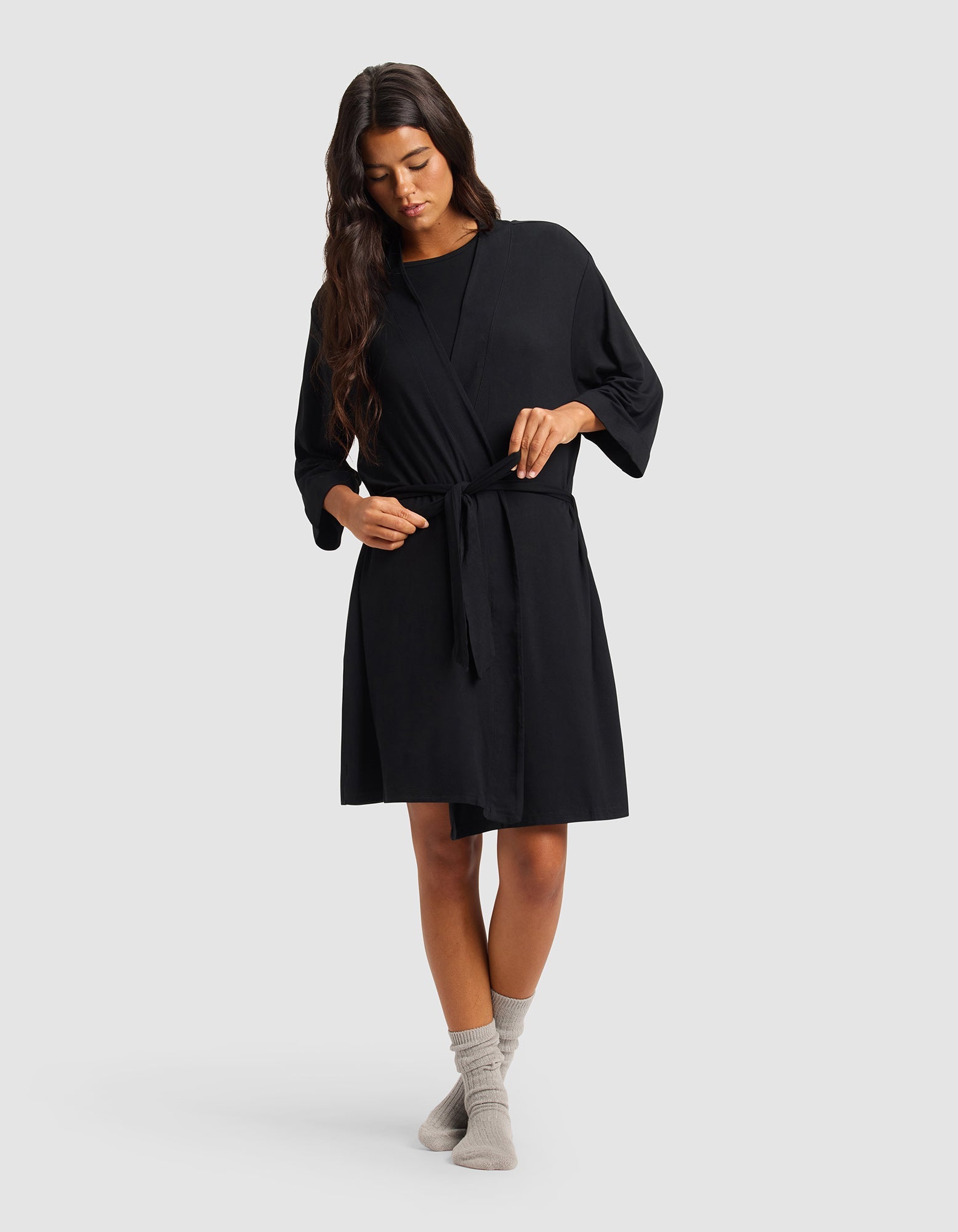 Black@woman wearing a black cozy earth robe
