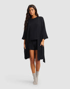 Black@woman wearing a black cozy earth robe