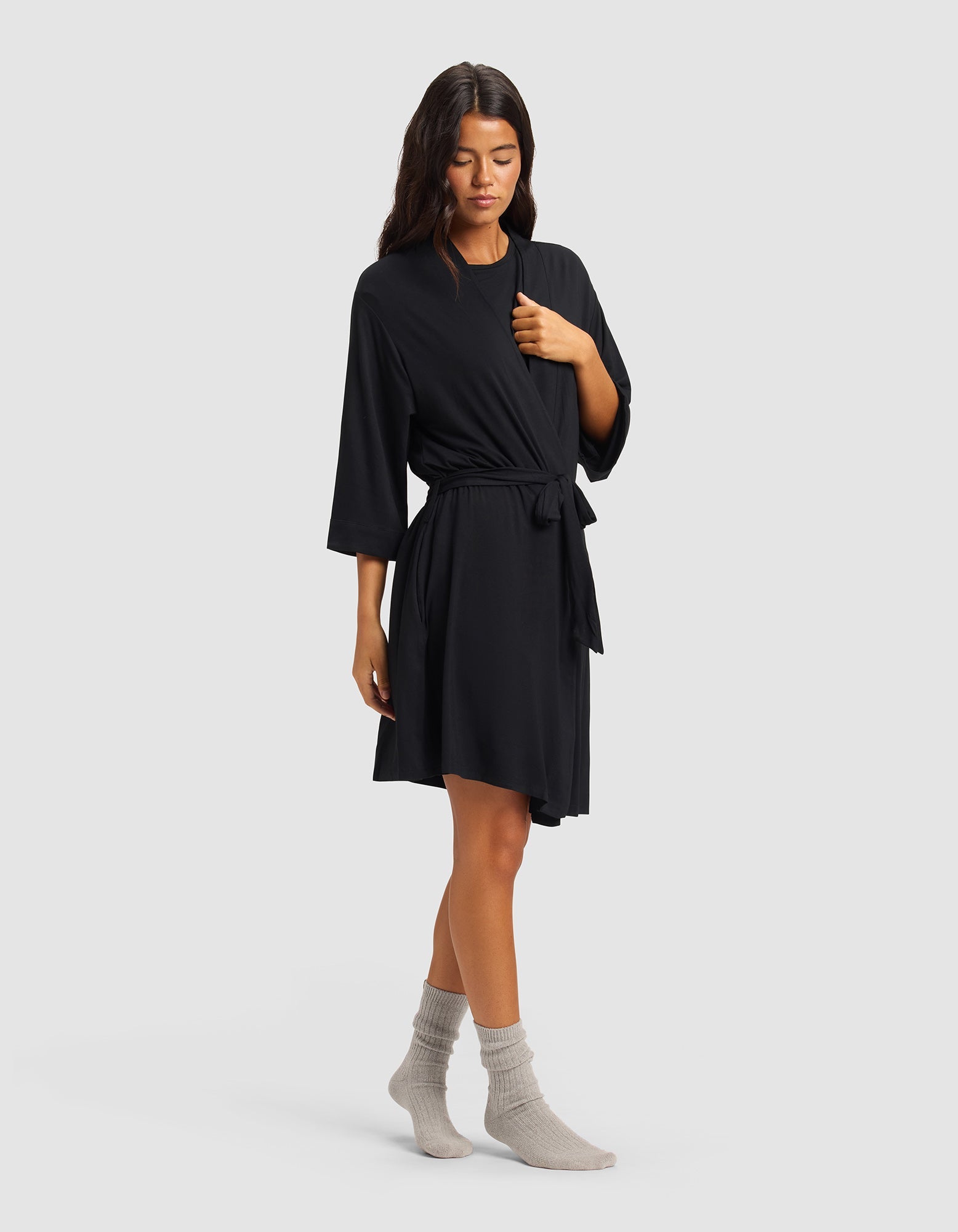 Black@woman wearing a black cozy earth robe