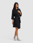 Black@woman wearing a black cozy earth robe