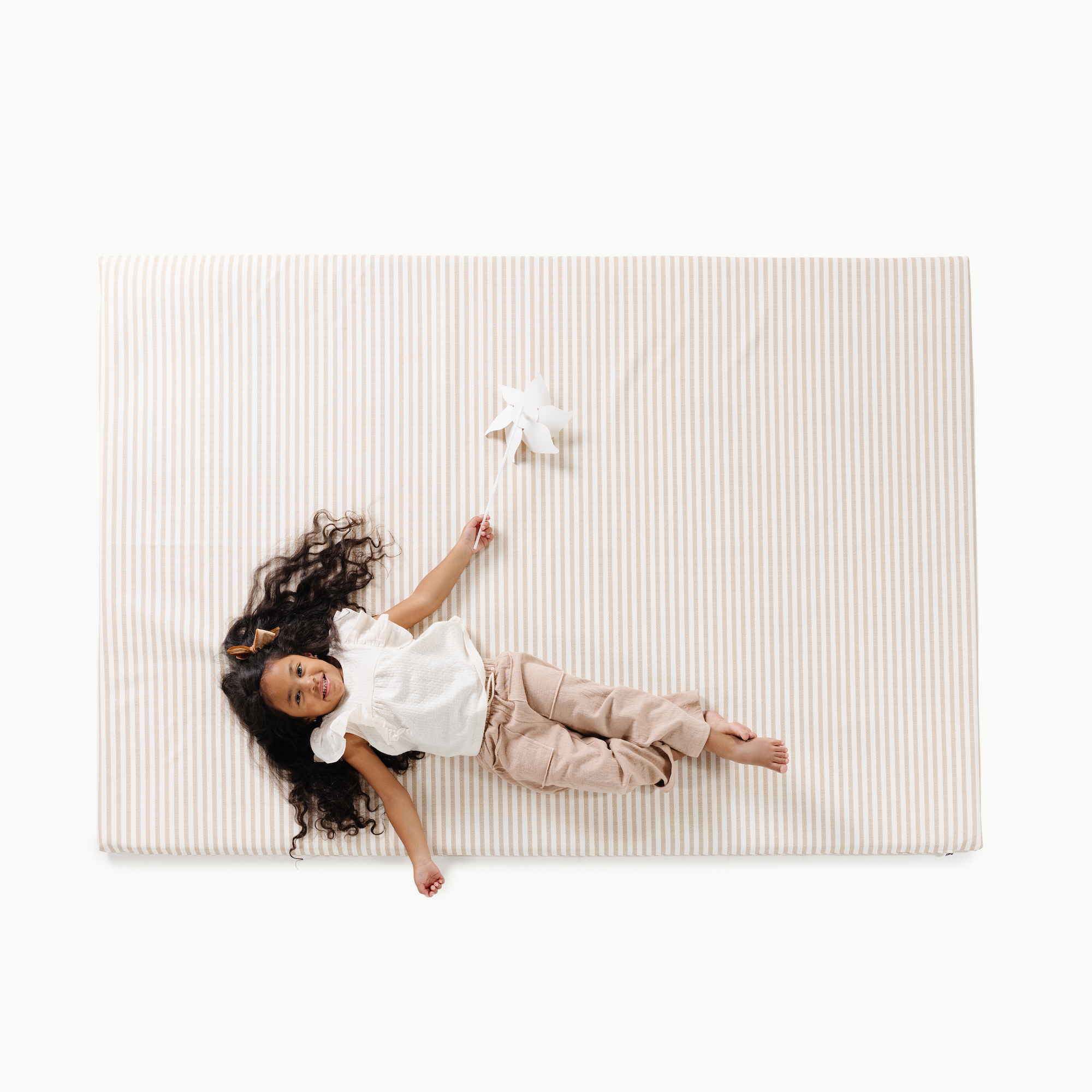 Cafe Stripe@overhead of kid playing on the cafe stripe padded midi+
