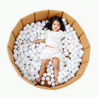 Camel@Child playing in a soft ball pit designed for babies and toddlers