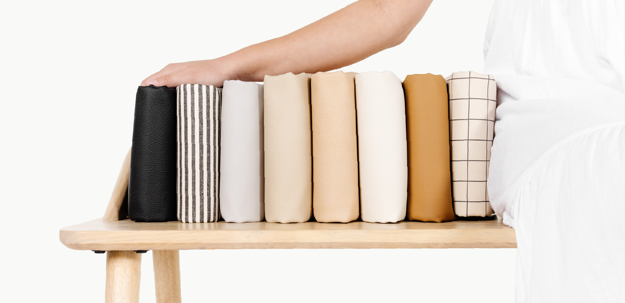 Woman sitting next to a stack of Gathre Mini Mats