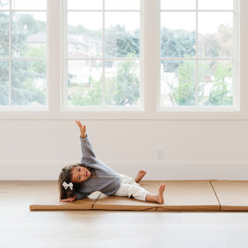 @Child rolling and playing on a comfortable tumbling mat