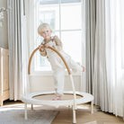 Ivory@Child using a low-profile indoor trampoline designed for balance and movement