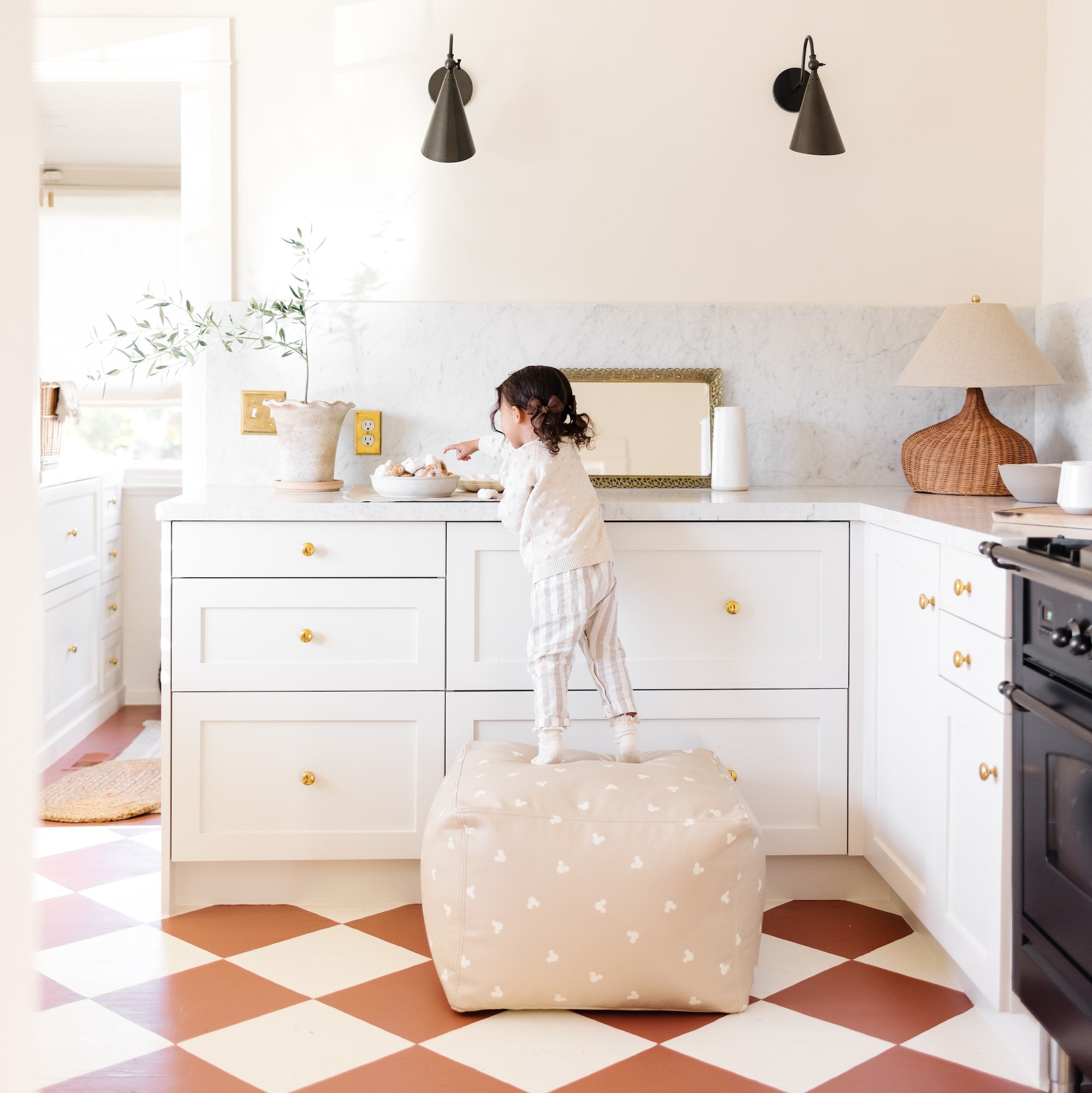 Mickey Mouse (on sale)@Kid standing on the Mickey Mouse Square Pouf in a home