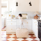 Mickey Mouse (on sale)@Kid standing on the Mickey Mouse Square Pouf in a home