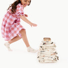 Uptown@Kid running towards stack of playmats