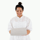 Gull (on sale)@Woman holding a folded Gull Midi+ Mat