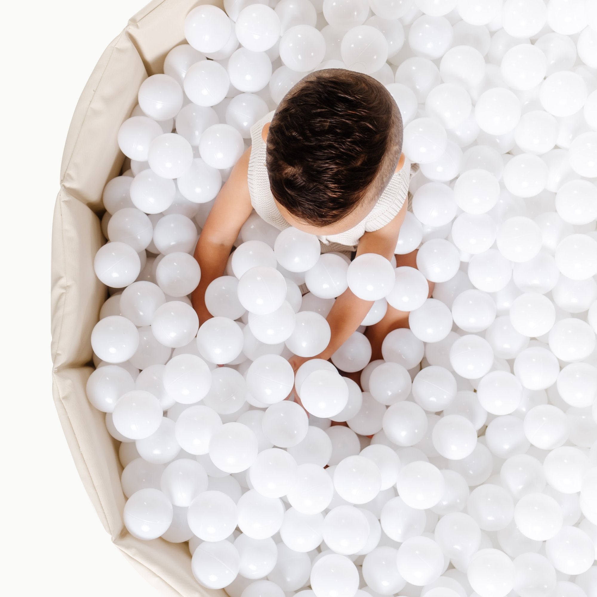 Ivory@Child playing in a soft ball pit designed for babies and toddlers