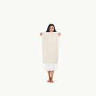 Ivory@Woman holding the Ivory Micro+ Mat