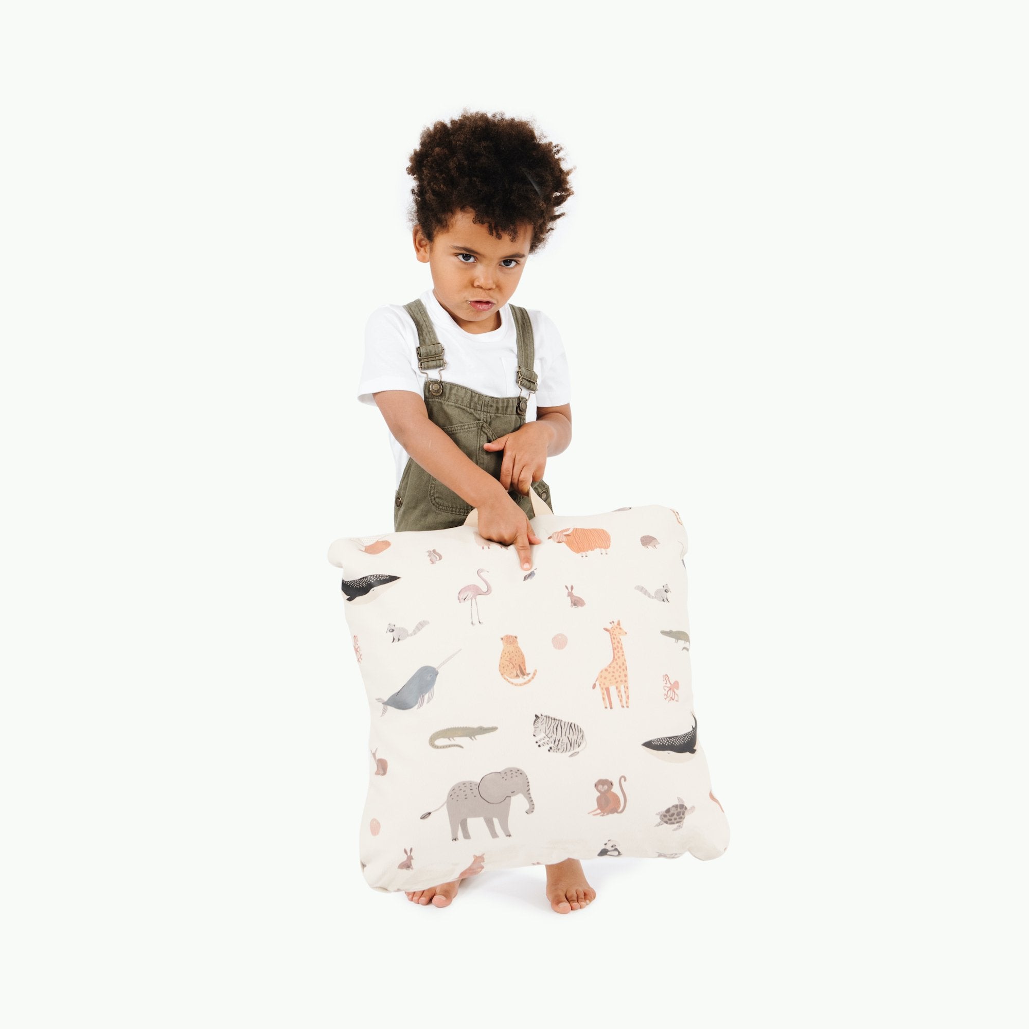 Menagerie (on sale) / Square@Kid holding the Menagerie Mini Square Floor Cushion