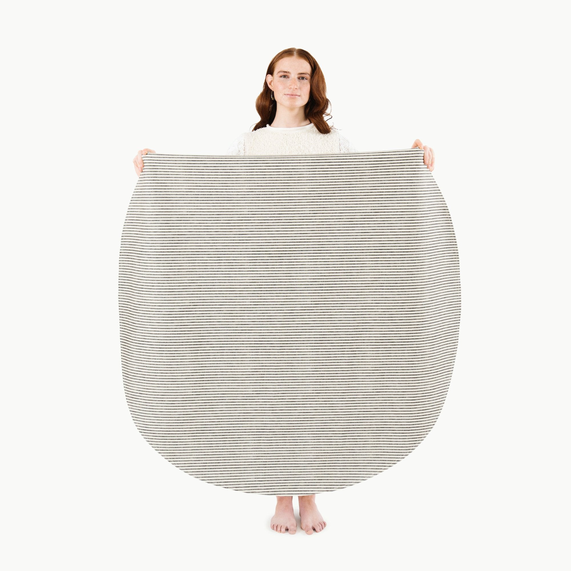 Stone Stripe (on sale) / Circle@Woman holding the Stone Stripe Midi Circle Mat