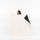 Ivory • Raven (on sale) / Square@Woman holding the ivory/raven midi mat