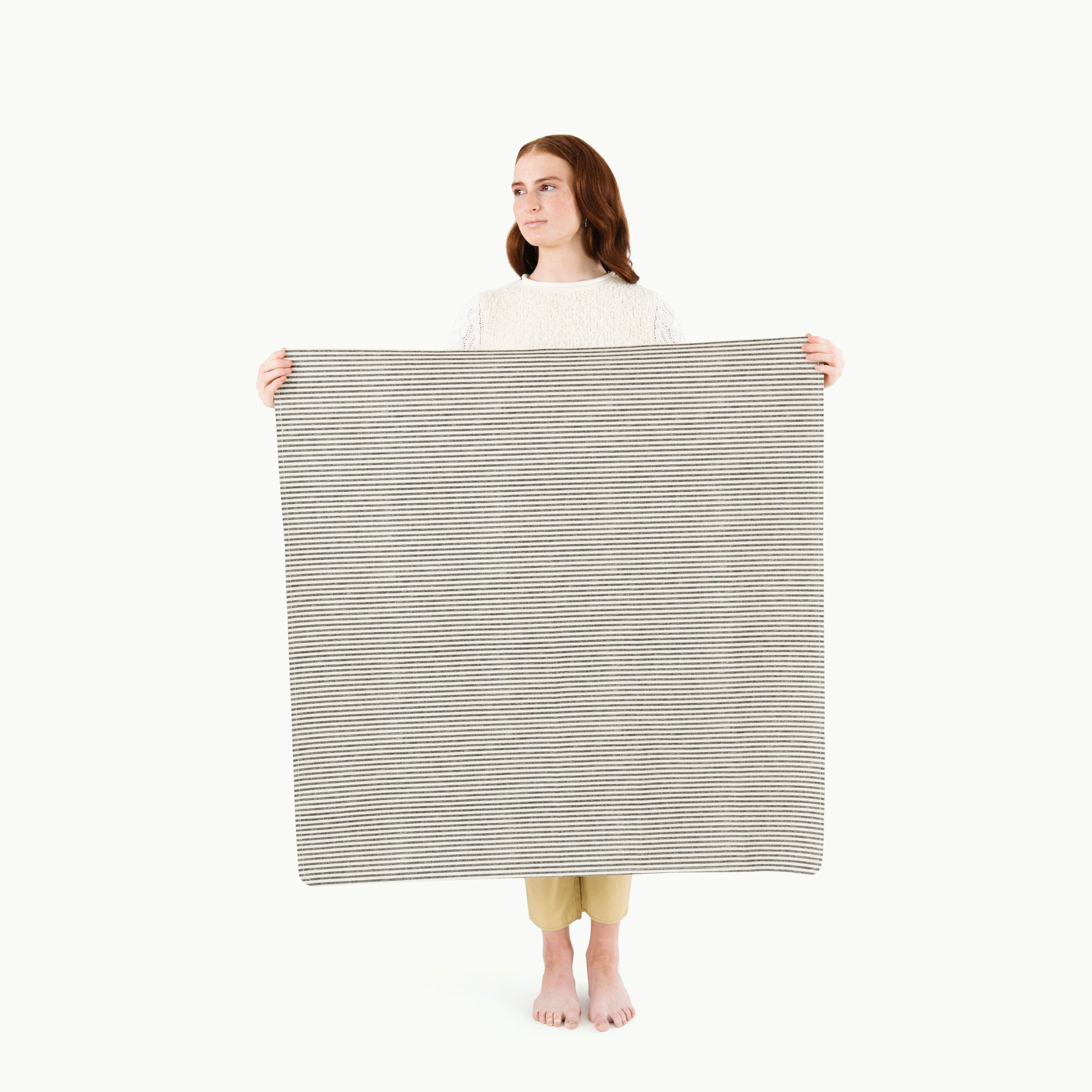 Stone Stripe / Highchair Mat@ Mini (Color) woman holding the mini stone stripe mat