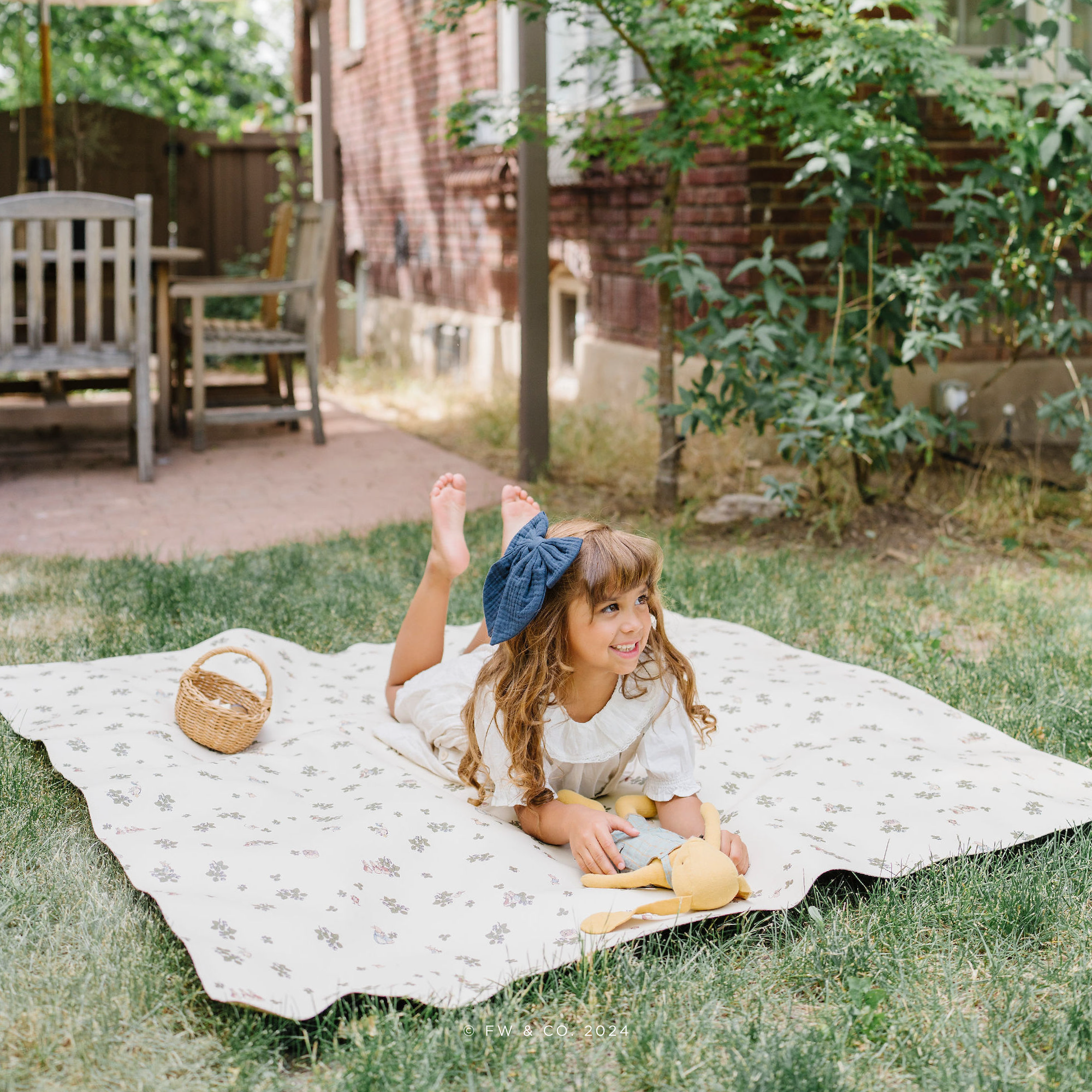 Peter Rabbit™@lifestyle image of little girl laying on Peter Rabbit™ mat