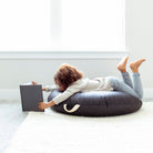 Raven (on sale) / Circle@Kid laying on the Raven Circle Floor Cushion 