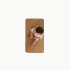 Tannin (on sale)@overhead of baby on the tannin micro+ mat
