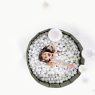 Thyme@Child playing in a soft ball pit designed for babies and toddlers