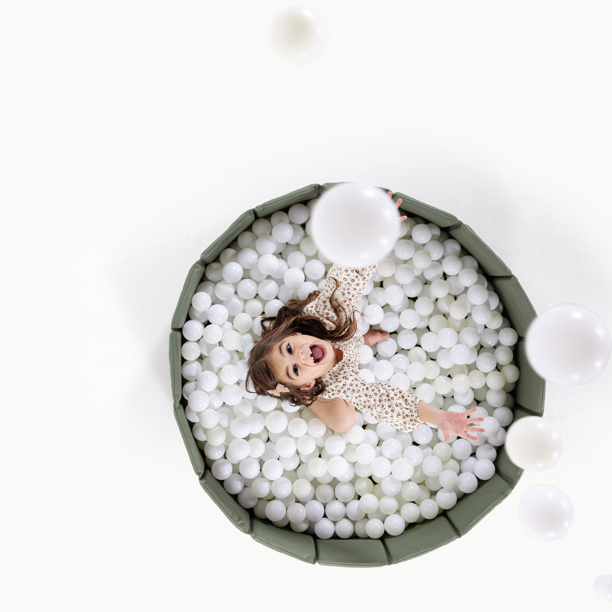 Thyme@Child playing in a soft ball pit designed for babies and toddlers