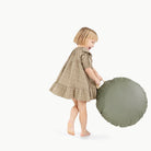 Thyme / Circle@Kid holding the Thyme Mini Circle Floor Cushion