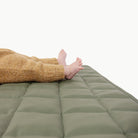 Thyme / Square@Close up of baby laying on the Thyme Square Quilted Mat