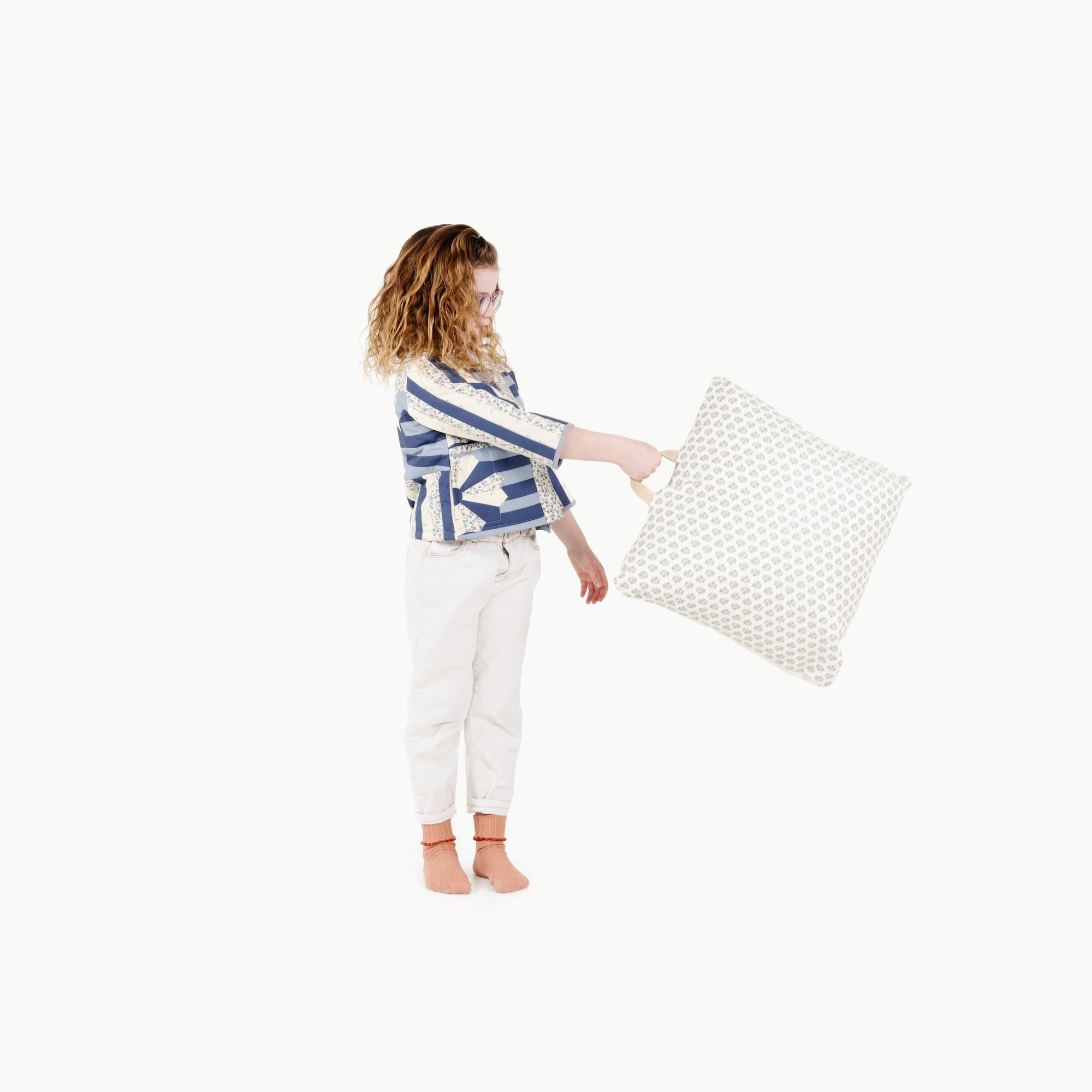 Meadow / Square@kid holding the meadow mini square floor cushion