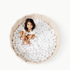 Bloom (on sale)@Child playing in a soft ball pit designed for babies and toddlers